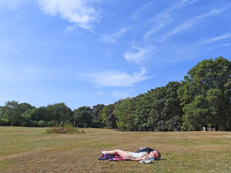 A sunbather on the parched grass in Hyde Park, Leeds.