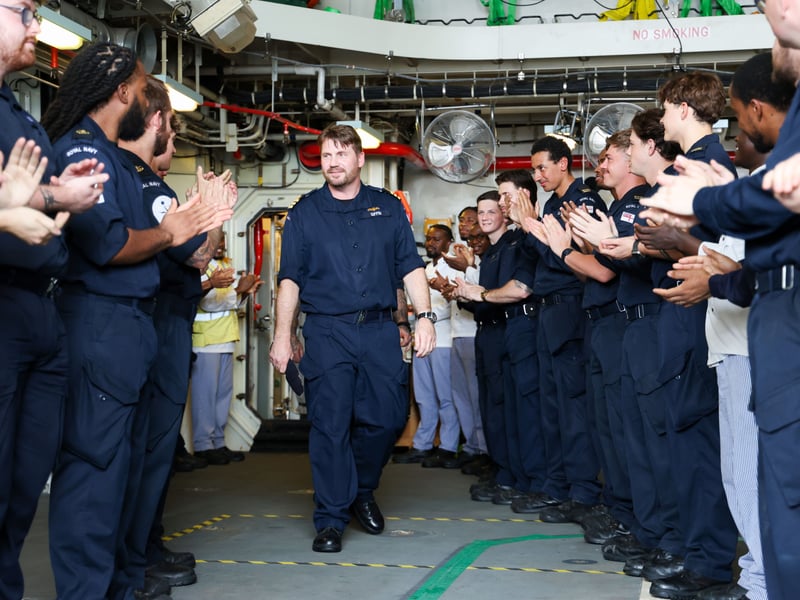 Commander Giffin receiving a round of applause from the ship's company.