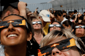 People wearing special glasses to look at solar eclipse