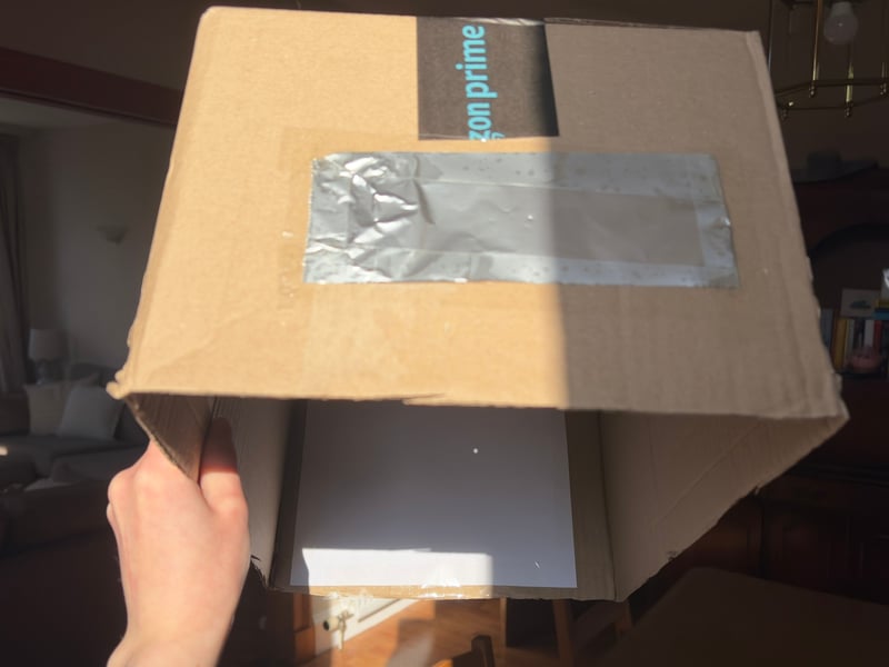 Once you have completed the steps, you can test out your projector. Holding the box upside down, face the pinhole side towards the sun and look at the sheet of paper inside the box. You should be able to see an outline of the sun.