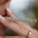 Stock image of a woman smoking a cigarette