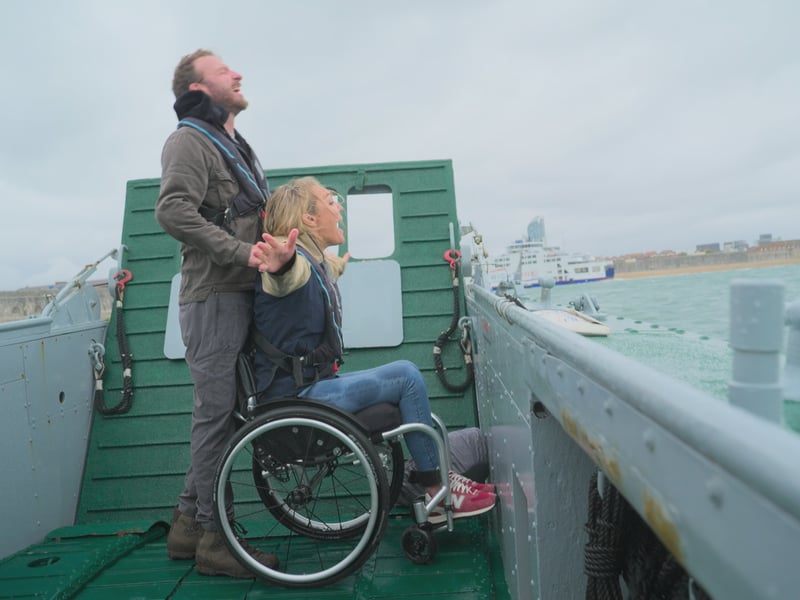 JJ Chalmers and Sophie Morgan being ferried across the water aboard an LCT.