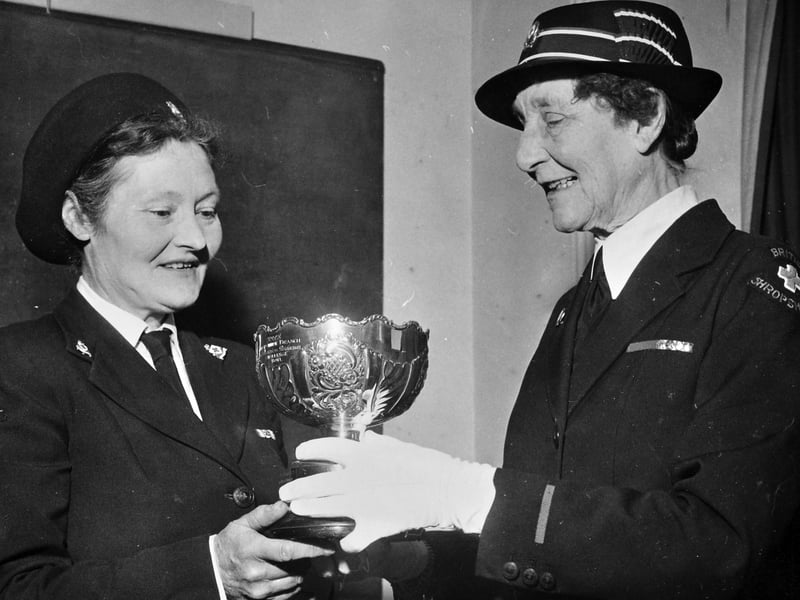 Mrs L Perkins (left), Commandant of Bridgnorth 28 Detachment, Red Cross, beams as she receives the Viscountess Bridgeman Bowl at the Civil Defence HQ in Shrewsbury on 24 March 1965. Presented annually to the county's most efficient detachment, the coveted trophy was handed over by Mrs T Urwick, honorary county Vice-President. The smart uniform presentation celebrates the dedication and community service of Bridgnorth's local volunteers during the mid-1960s. Were you involved with the Bridgnorth Red Cross detachment in 1965, or do you remember Mrs Perkins and her award-winning team?