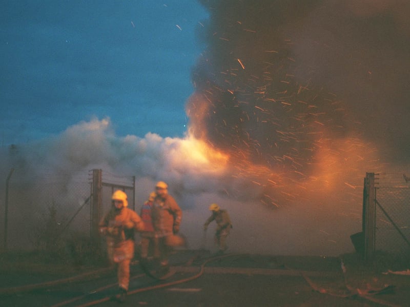 Sparks and flames grip the building as firefighters rush to bring up more equipment