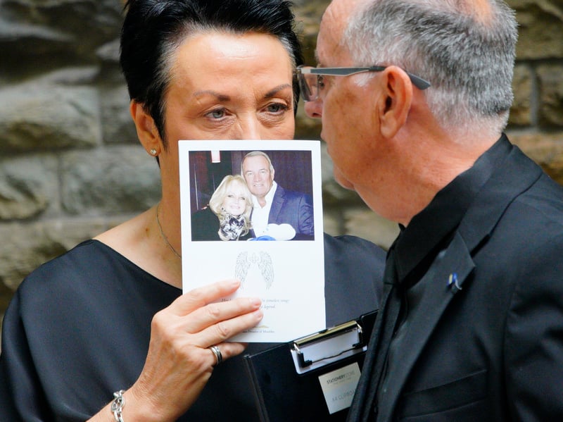 A person holding an Order of Service ahead of the funeral of Bonnie Tyler at Swansea Minster.