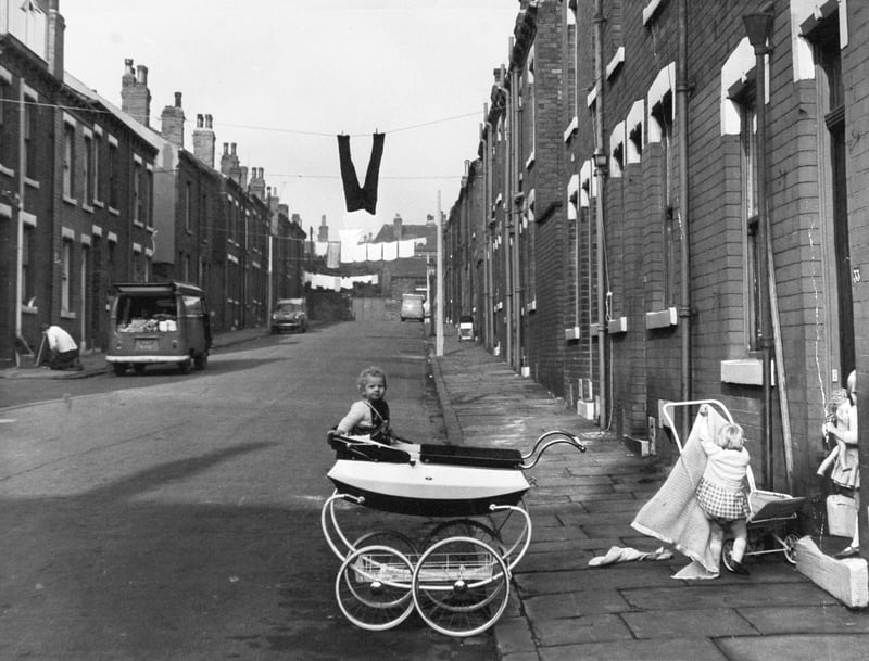 Children play on the street, with washing hanging between houses, on Autumn Grove, Leeds, in October 1968. It was one of the streets included in Leeds Corporation's modernisation plan for a 'twilight' area of the city.