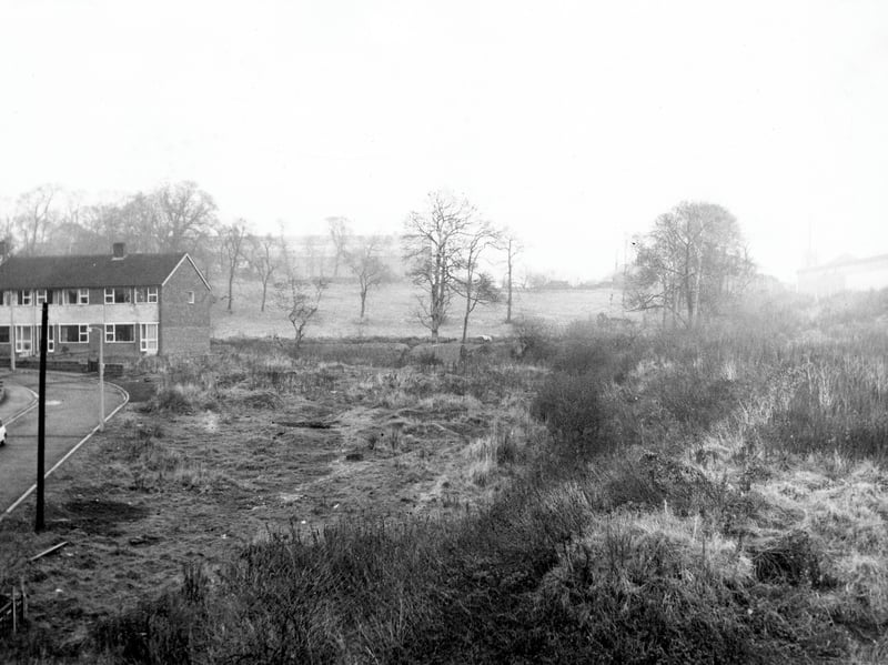 Somerdale Gardens on the left with houses numbered 17 and 19 to be seen on the corner. The rest of the photograph is taken up with wasteland, fields and trees with the faint outline of Bramley Bus Garage on Henconner Lane seen behind the trees in the distance. Pictured in December 1968.