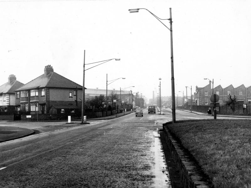 The view from December 1968 looks west along Stanningley Road towards Town End. Green Hill Mount can be seen on the left. The Regent garage, J. & C. Ltd. serge manufacturers and Thomas I. Bennett Ltd. car sales and service building can be seen on the left.