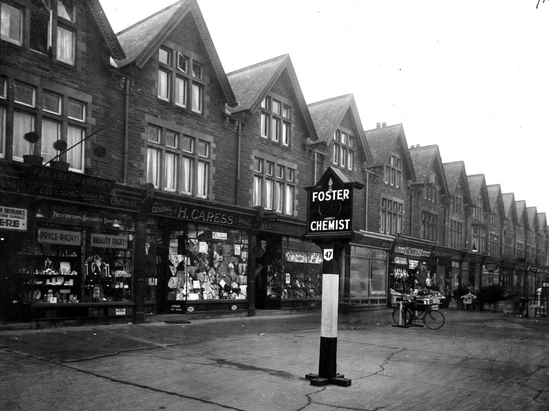 A parade of shops on Street Lane in December 1932. On the left is no 47 Ernest Carrick Foster chemists shop is on the pavement. Next to the right is no 49 H Caress and son, drapers, then no51 Amos Webster, boot and shoe shop. The shops continue Newbys greengrocers at No55 is behind the delivery bike on the pavement. The shops end with no 81, at the junction with Sutherland Avenue.