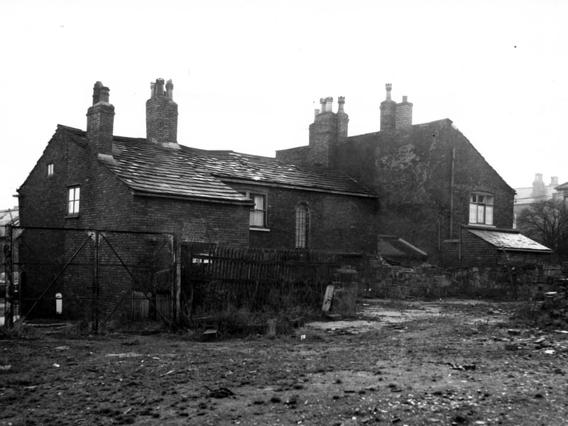 Rear view of properties on Chapel Lane with the rear and side walls of number 20, then 22 Second Fold to the right. Property included in the Armley slum clearance area.