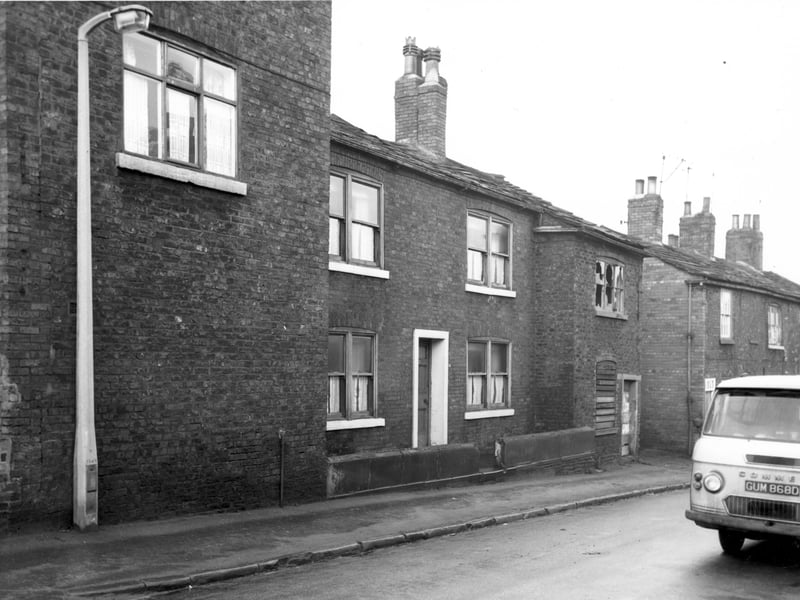 A view looking along even numbered side of Chapel Lane in December 1967. The side wall of number 20 is visible on the left edge. Moving right numbers 18, then 16 which is derelict. Across the gap on the right edge are numbers 6 and 4. Included in slum clearance plans for Armley area.