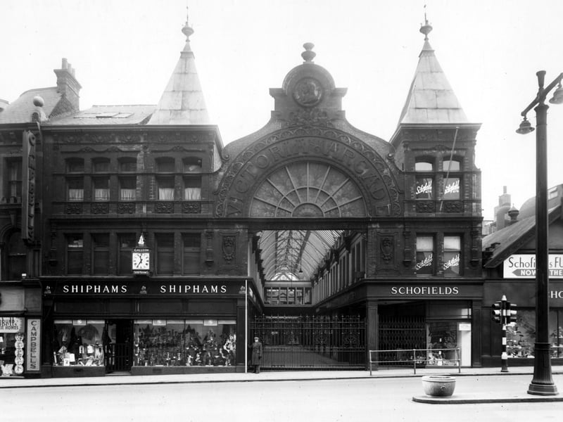 View looks straight down Victoria Arcade from The Headrow. Shops featured are Campbells furnishers, H.G. Shipton Ltd. hosiers, Schofields department store. Pictured in December 1949.