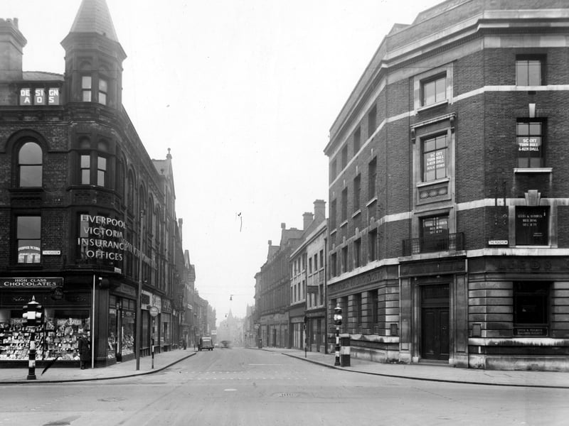 The junction of The Headrow with Albion Street looking straight down Albion Street. On the left G.W. Watson confection and the Liverpool Victoria Insurance. On the opposite corner is the Leeds and Holbeck building society, with the offices of Scott, Turnbull and Kendall solicitors above. Pictured in December 1949.