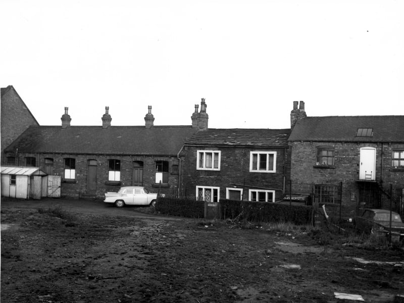 To the left of this view, the back of Mosley and Richmond Ltd Stationery printers, occupying nos. 4 to 10 Stocks Hill. Moving right, number 12 is a private residence, then number 20 Stocks Hill on the right, the rear entrance to premises of Les Sharp upholsterer. This area was sometimes referred to as Forbes Yard.