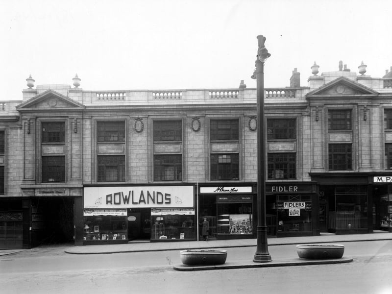 The south side of The Headrow in December 1949. On the far left is the entrance to Bramley's Yard, then number 21/23, Rowlands Bros, furnishers. Number 25 is H. Brown and Sons, grocers, number 27 Fidlers, furnishers, number 29, B.J. Hollingsworth, chiropodist.