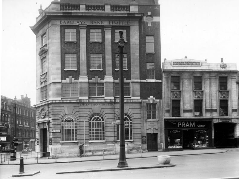 The south side of The Headrow in December 1949 just west of the junction with Vicar Lane. Premises shown are number 1 Barclays Bank Ltd. with their chambers at number 3. Number 5 is Lithgow Ltd. the pram shop. Next is Rockley Hall Yard. Down Vicar Lane Direct Woollen Supply and Jack Appleyard clothier can be seen.