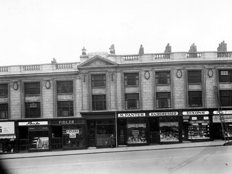 The south side of The Headrow in December 1949. Number 25 is H. Brown and Sons, grocers, number 27, Fidler's Furnishers, number 29 B. Hollingsworth, chiropodist, number 31/33 is M. Panter, Haidressers, number 35 is J.R. Dixon and Sons, Tobacconists and number 37, Kays Hosiery.