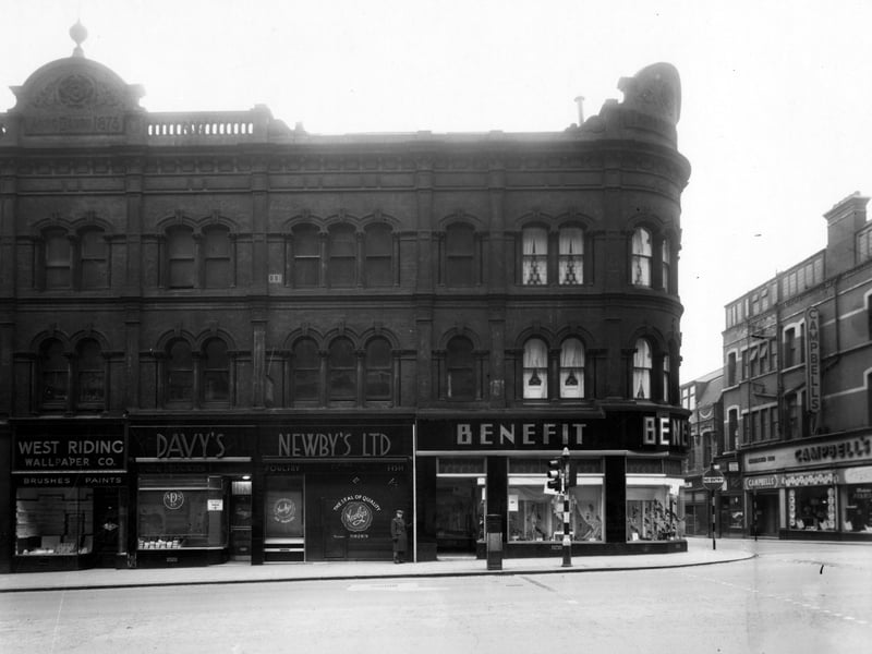 Numbers 61a to 73 The Headrow on the South West side. Premises include, 61a the West Riding Wallpaper Co., 63 is Davey's Provisions, 65 is Newby's Ltd. Fish and Poultry, 67 is Benefit Footwear Ltd and over Lands Lane, number 73, Campell and Co, furnishers. Pictured in December 1949.