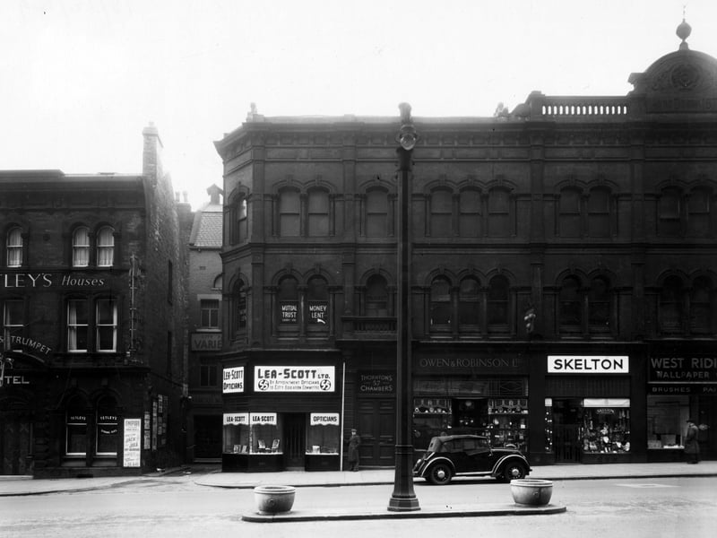 The south side of The Headrow showing number 51 the Horse and Trumpet Hotel, then, set back, is Leeds City Palace of Varieties. Number 55 Lea-Scott Ltd. opticians, 57 Thornton's Chambers (including Mutual Trust (Leeds) Ltd.), number 59 Owen and Robinson Ltd. jewellers, 61 E. Skelton hosier, 61A West Riding Wallpaper Co.