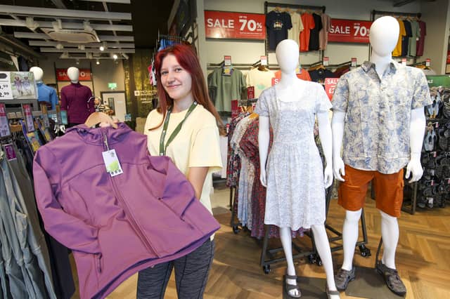 Darcy Brooks holding a woman's soft shell water resistant jacket at the new Mountain Warehouse in Gunwharf.