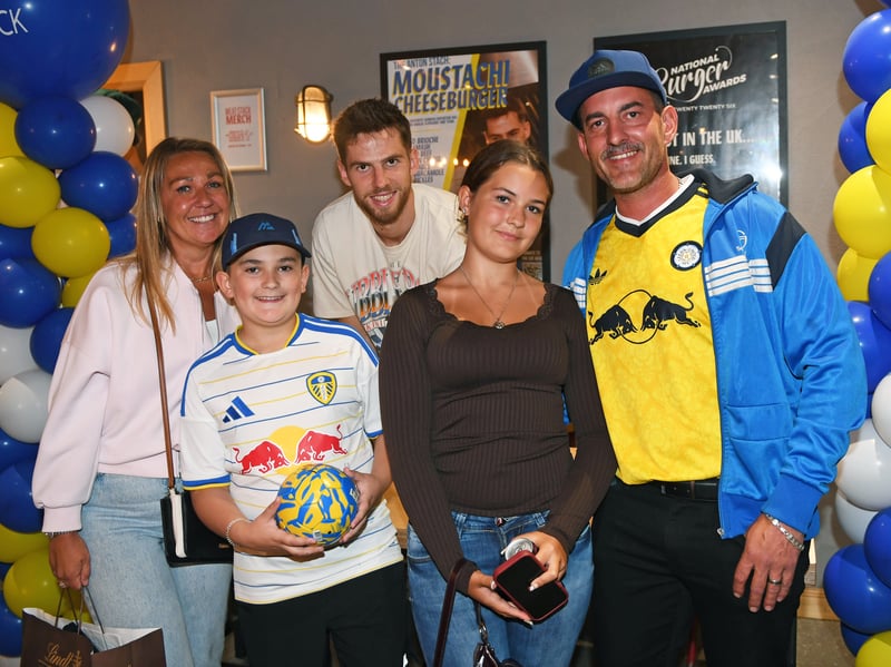 Anton Stach poses with fans for a photograph