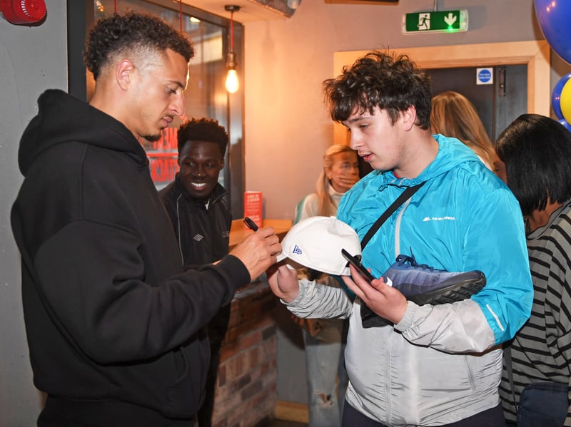 Leeds United's captain Ethan Ampadu signs a cap for a fan