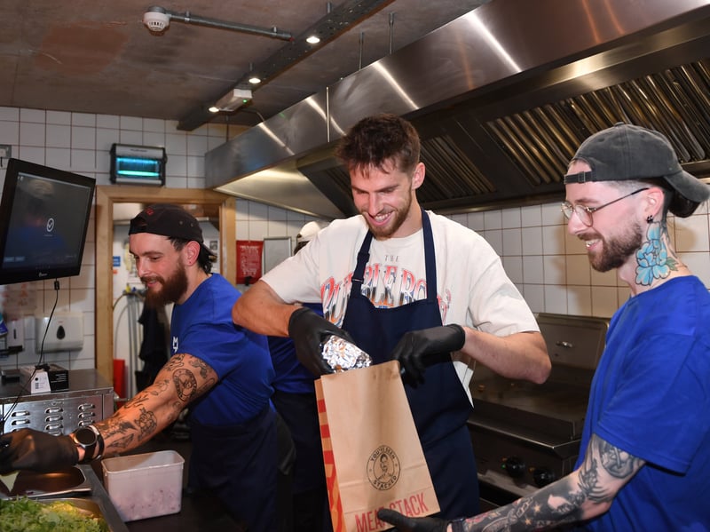 Anton Stach prepares one of his signature burgers to be served up at Meat Stack