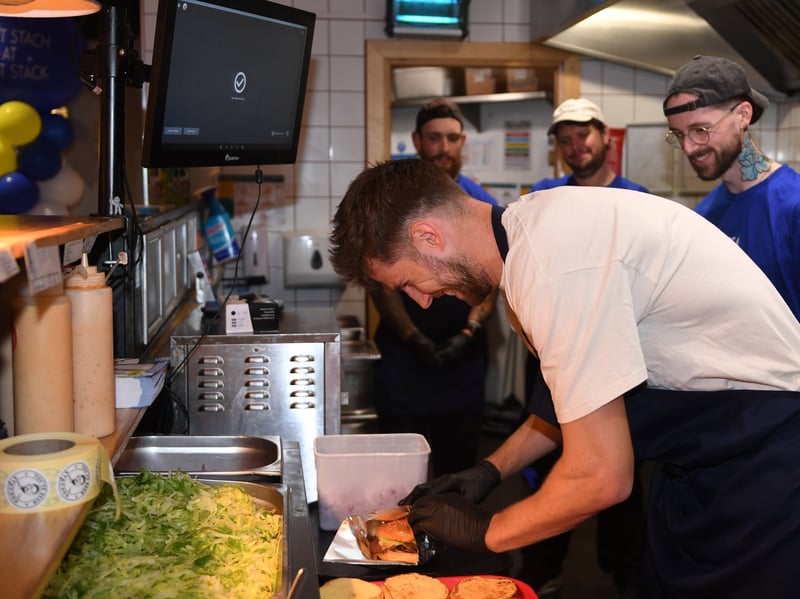 Anton Stach working in the kitchen making his burger