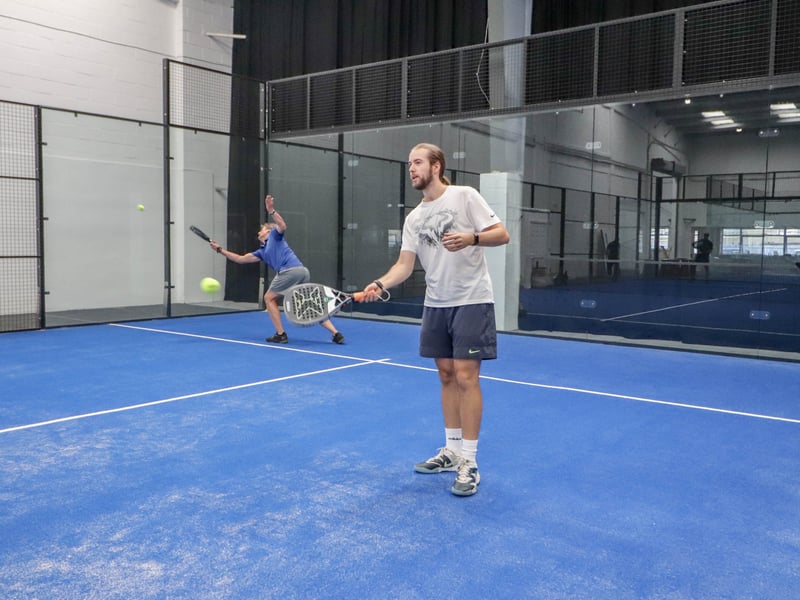 Padel coaches warm up ahead of a game.