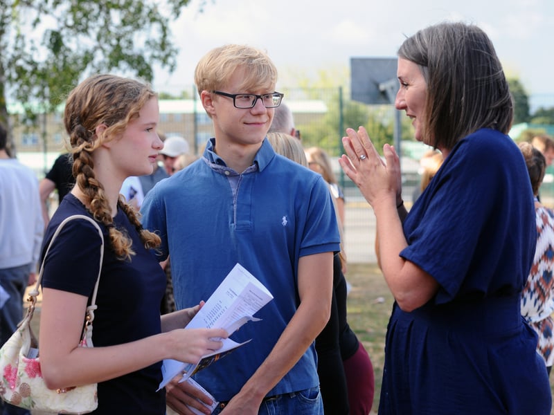 Students picked up their GCSE results at King's Academy Brune Park in Military Road, Gosport.

Pictured: Headteacher Kerry Payne talking to Chloe Bryan (16) and Troy Toastivine (15).

Picture: Sarah Standing (200826-8002)