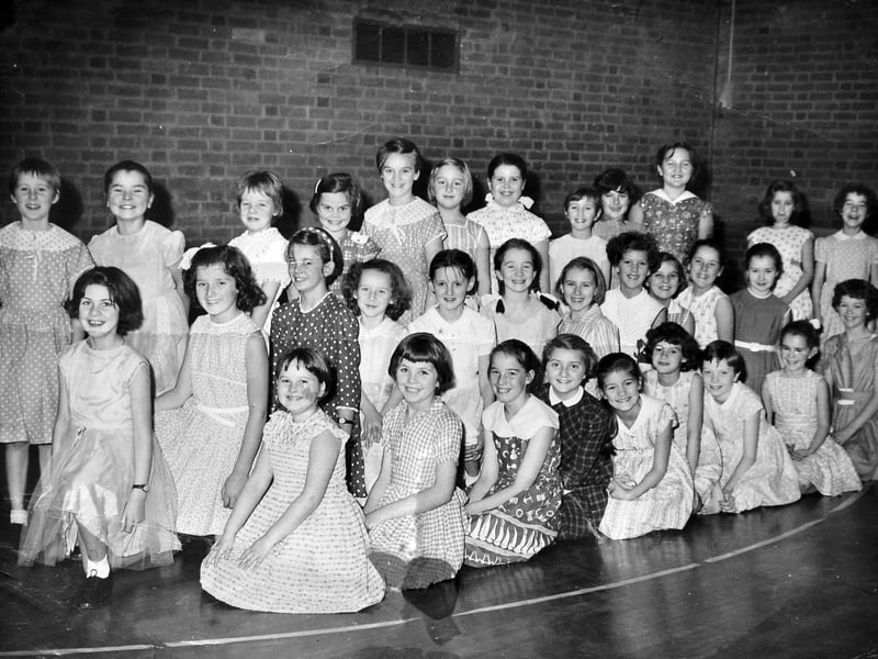 All smiles from this charming group of young girls. The picture was in our old Bridgnorth office, so they are likely to be from that area, and that looks like a gym floor. Recognise anybody?