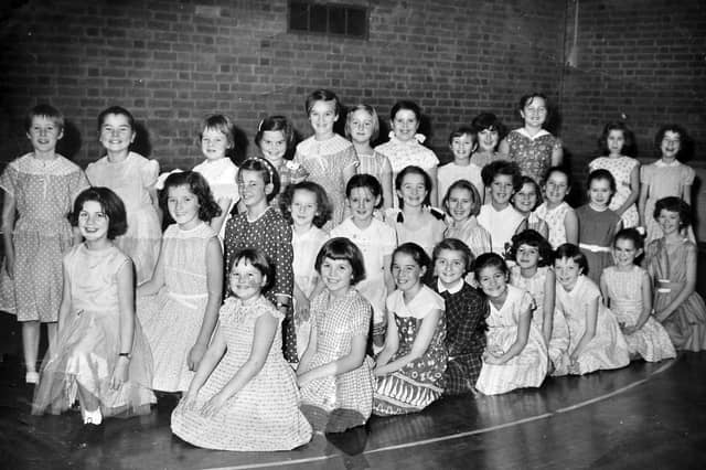 All smiles from this charming group of young girls. The picture was in our old Bridgnorth office, so they are likely to be from that area, and that looks like a gym floor. Recognise anybody?