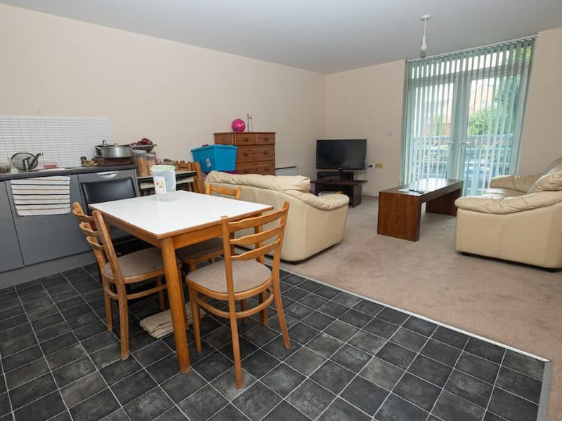 The patio windows allow daylight into the open plan living space