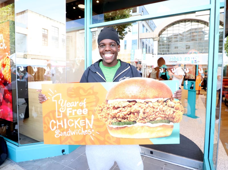 The second customer in the queue, Bobby, 19, with his award of one year of free chicken sandwiches.