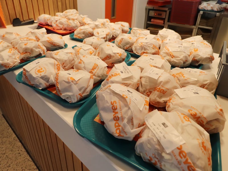 Free chicken sandwiches ready to be handed out.