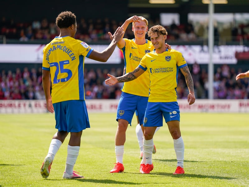 Pompey players celebrate with Adrian Segecic after his free-kick goal. Picture: Jason Brown