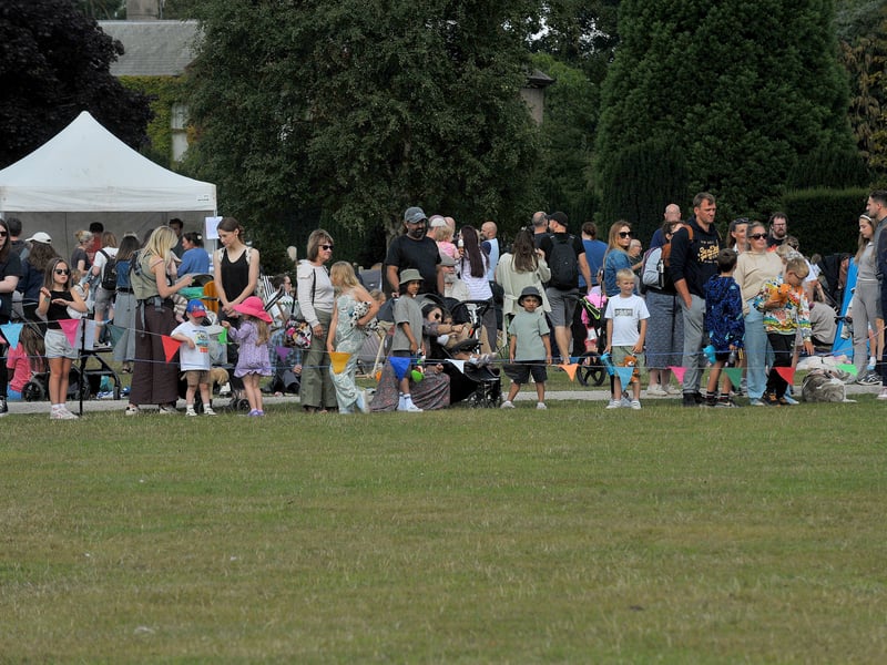 Families watch the teddy parachute drop.