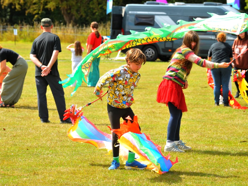 Youngsters with handheld kites.