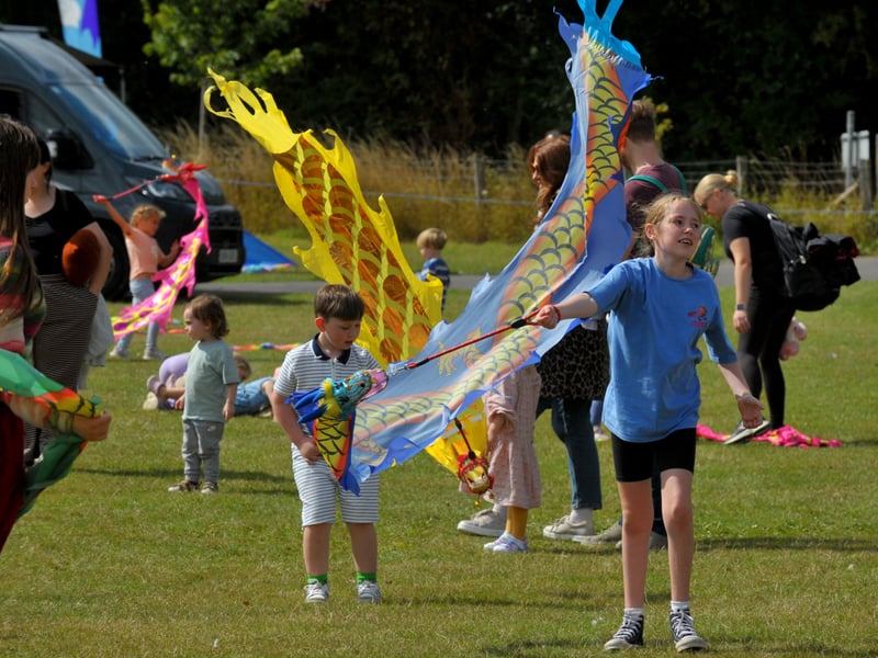 Youngsters with hand held kites.