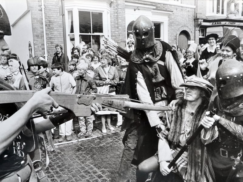 A cavalcade of Tudor troops led by Henry Tudor descends upon the town of Newport on August 15, 1985, bringing history dramatically to life. Pictured pleading for peaceful entry on behalf of local merchants is Ray Edwards of the Newport and District History Society, who finds himself held under guard by men-at-arms and bowman Mark Ireland. The dramatic reenactment was held to mark the 500th anniversary of the Battle of Bosworth. Do you remember watching the medieval procession take over Newport's streets back in the summer of 1985?
