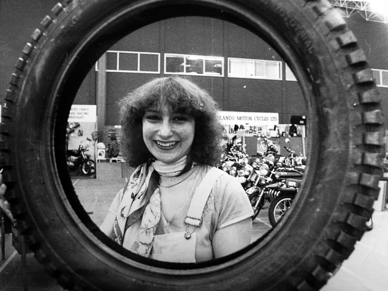 Seen through one of the tyres she was selling at the tenth annual Midland Motor Cycling Show at Walsall's Alumwell Centre is Louise Newman, of Solihull.
Motorcycling enthusiasts who went along
in February 1980 got a preview of some of the new bikes about to come on the market. Special competition cycles and sporting bikes were also on display at the four-day event which was attended by more than 5,000 people.