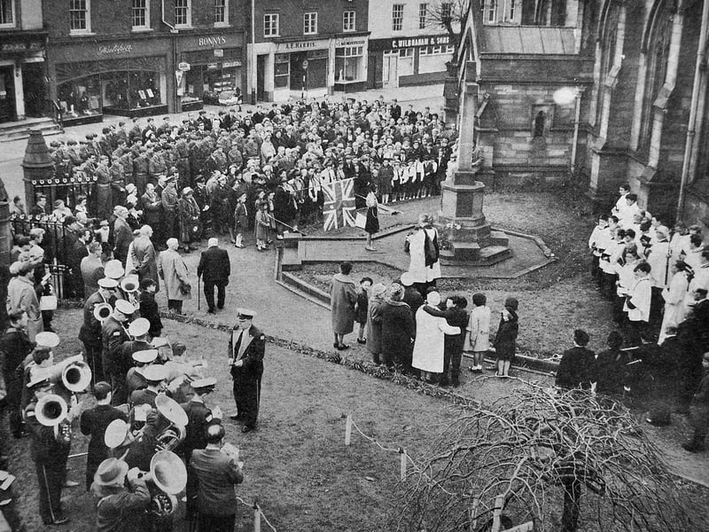 A Girl Guide lays a wreath at the war memorial at Newport Parish Church during a Remembrance Day service in November 1964. Members of local organisations, a band, choir and the public gathered in silence to honour those who had lost their lives in war. Do you recognise anyone in the crowd, or remember Remembrance Day services in Newport from years gone by?