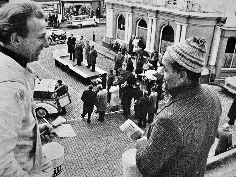 Painters get a bird's-eye view as Lord Bradford performs the opening ceremony for the Newport Civic Trust Scheme in October 1964. The scheme had given the town's two main shopping streets a facelift, with shop doorways among the features receiving a fresh coat of paint. Do you remember Newport's shopping streets looking like this, or the changes made under the Civic Trust scheme?