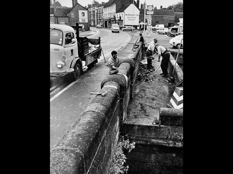 Shropshire County Council workers repair the canal bridge in Newport in August 1974 after a car crash demolished part of the wall. The bridge, an ancient monument, spans the canal over the roving lock, where horses pulling boats could change sides. Can you remember this bridge before the repairs, or watching boats make their way through the lock?