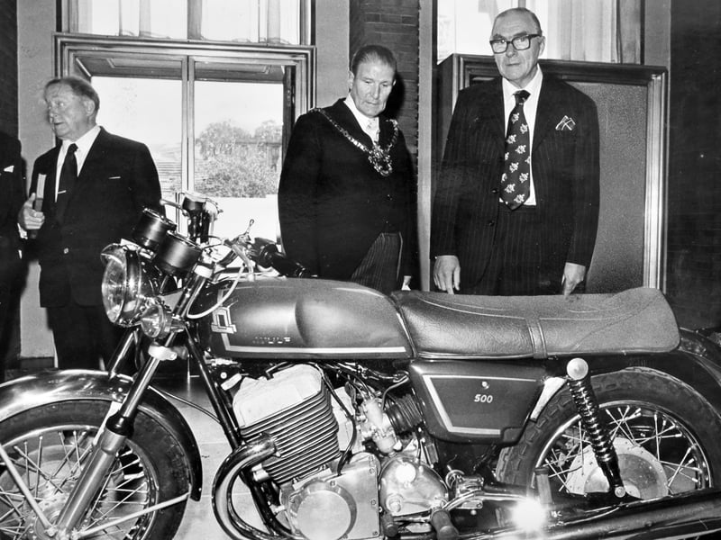 A Wolverhampton-made Wulf motorcycle on show in 1975 when the British motorcycle industry was in its death throes. All the hopes and prayers of sacked Villiers workers were pinned on the future of the revolutionary motorcycle, which was intended to be made in the Wolverhampton factory of Norton Villiers. A 1,000-strong congregation packed into the Civic Hall for a people's service and offered a few words for the men and their machine. There was an air of reverence from the men, women, and children as they walked past the shining new Wulf, parked in the foyer of the Civic Hall, where the Mayor of Wolverhampton, Councillor Ted Mitchell, is pictured here looking at the machine, with John Boyd, general secretary of the Amalgamated Union of Engineering Workers. Sadly this proved to be the one and only Wulf.