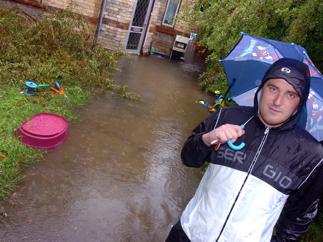 Lee Neath outside his Whittington Street, Doncaster, rented home which is surrounded by flood water. It was flooded during the last heavy downpour of rain, and he was expecting it to be flooded once again.