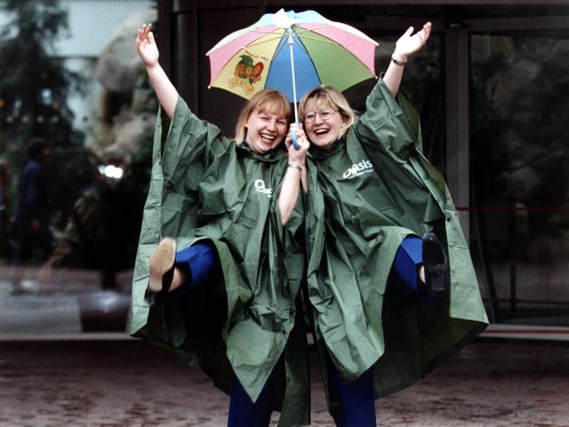 Singing In The Rain. Going Places Travel advisors Karen Barley, left, Dawn Fielding, right, celebrate sales & customer service honour after sending Doncaster folk to sunny climes. 