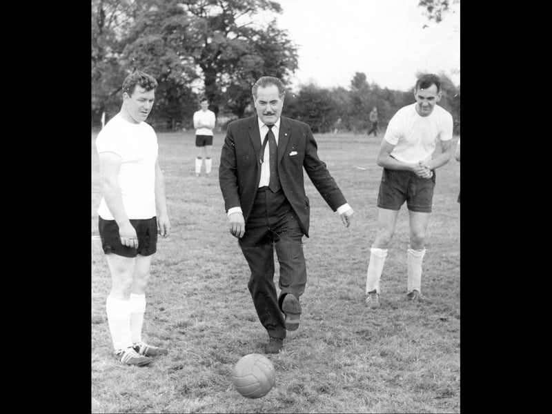 Actor Monte Crick, better known to *The Archers* listeners as Dan Archer, kicks off a friendly football match after opening Audco Engineering Company's new playing field at Audley Avenue in September 1964. Standing beside him is Dave Dudley, captain of the Audco team, who supplied the photograph. Dave recalled that the field was still there decades later, next to the cemetery. Do you remember Audco's football team, or watching matches on this pitch?