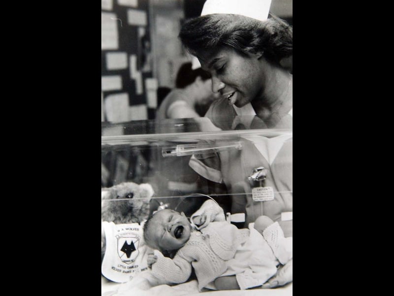 Hospital staff nurse Lyndola Dillon cuddles baby Steven Patrick on March 18, 1989, with a teddy bear sporting a Wolverhampton Wanderers baby bib beside him. The hospital isn't named, but the little football-themed touch gives this charming picture a distinctly Black Country feel. Do you remember the Wolves baby bibs, or the hospital where Steven was born?