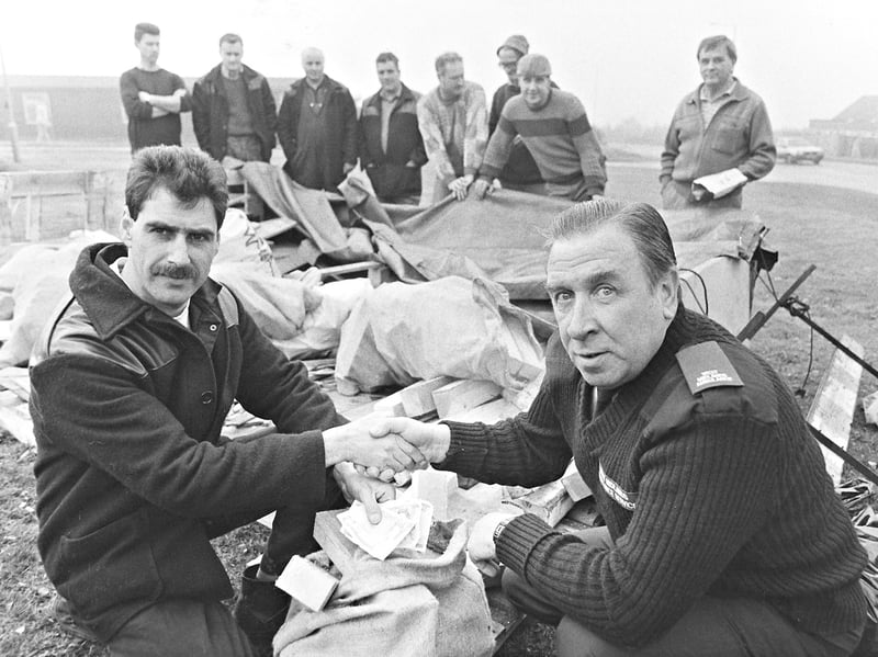 Workers from Rapid Metal on Stubbers Green Road and BRD Engineering on Dumblederry Lane joined forces to support an ambulance crews' hardship fund in December 1989. Roger Broadhurst is pictured presenting cash and wood to Pat Burrows on Leighswood Road, Aldridge. Do you remember local workplaces coming together to support good causes like this?
